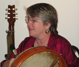 Brenda, playing bodhran at the Phoenix and Dragon Bookstore